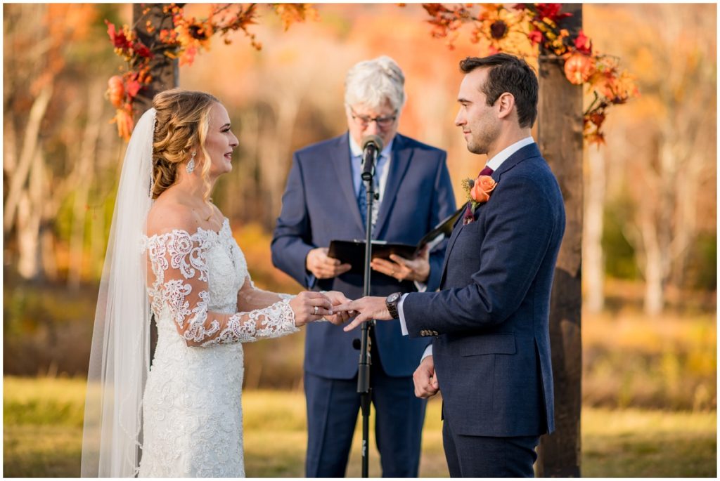 Bride and groom at alter in outdoor ceremony in NH. Barn Wedding in NH